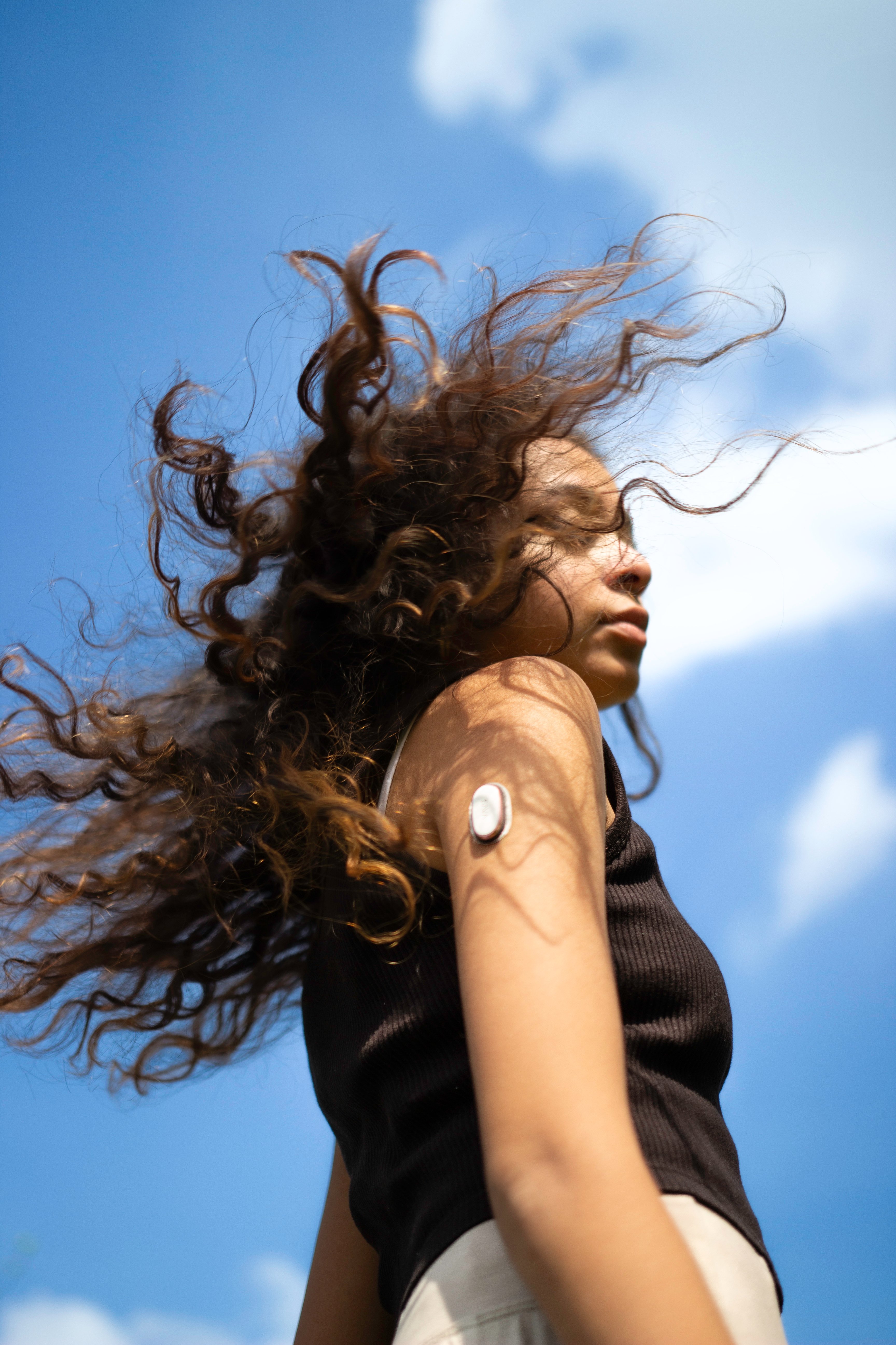 Woman wearing a wearable glucose monitoring sensor